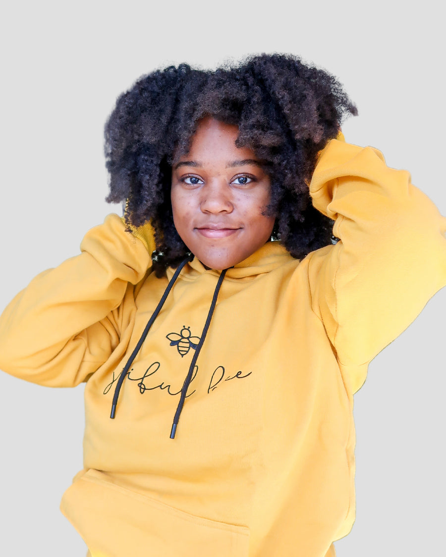 black woman in yellow hoodie