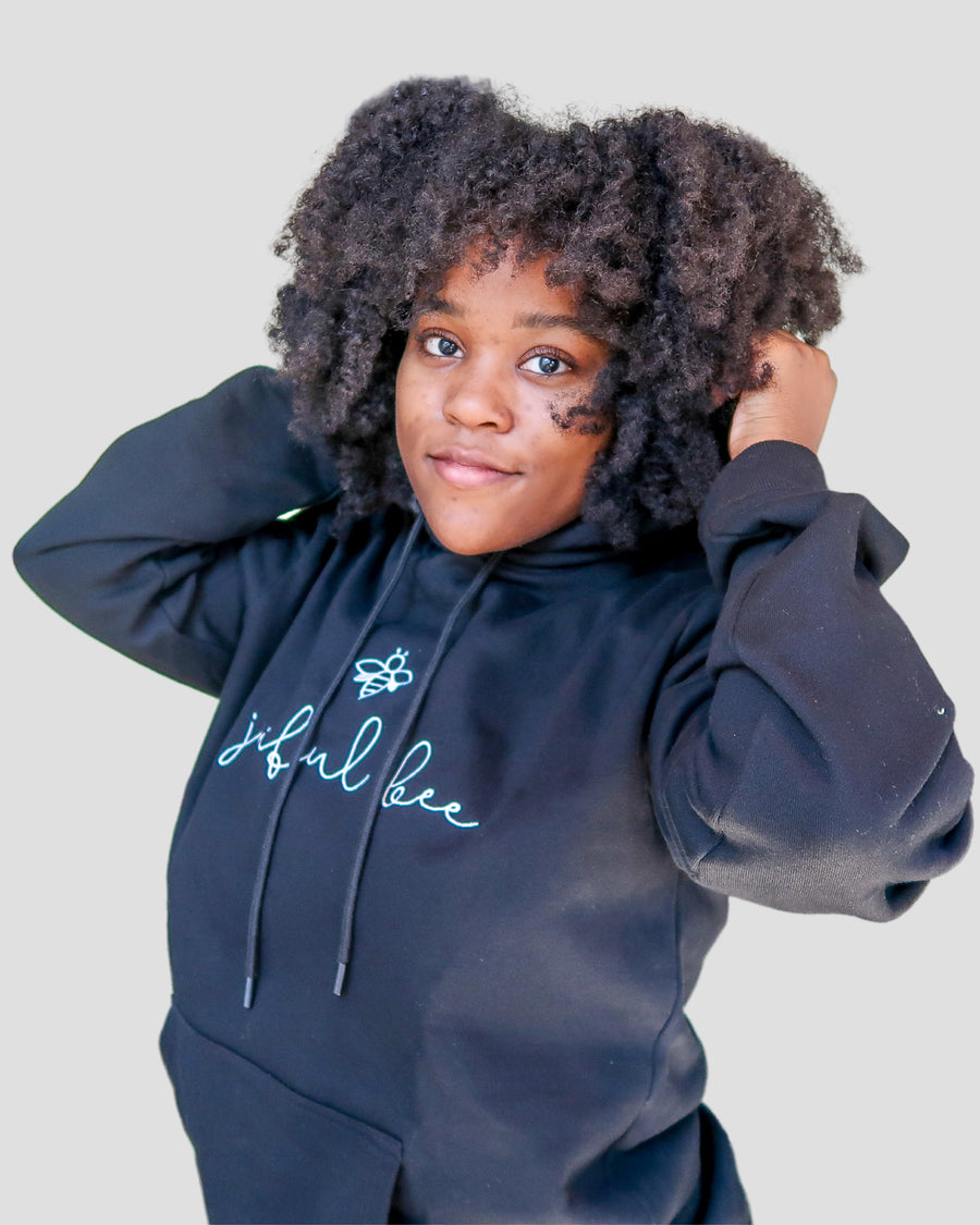 black woman in satin lined hoodie with natural hair
