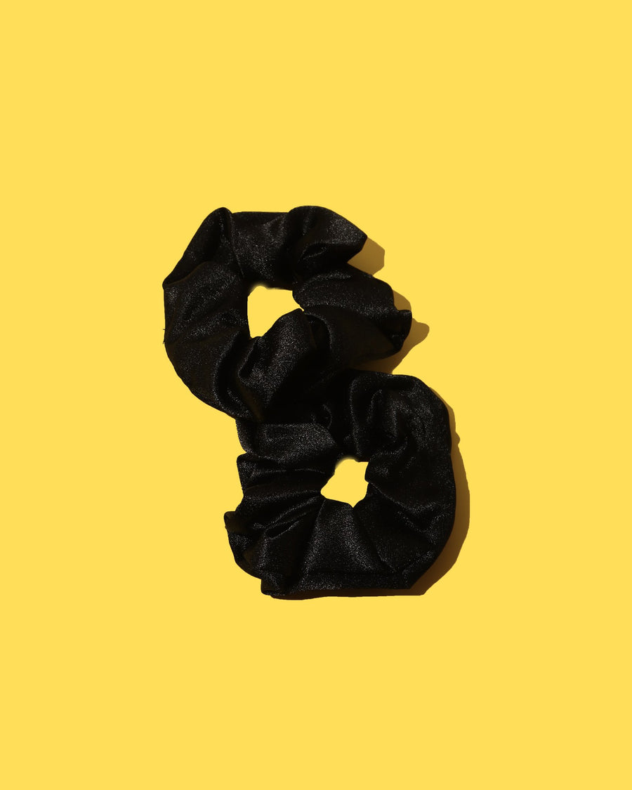 black satin scrunchies on yellow background